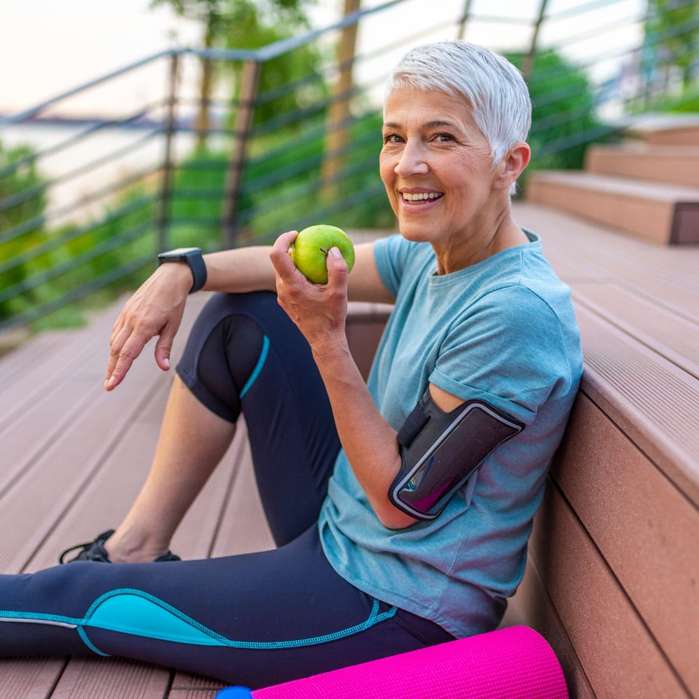 women eating an apple after workout