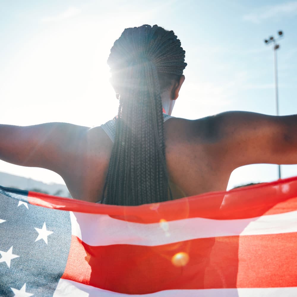 USA olympic athlete holding flag 