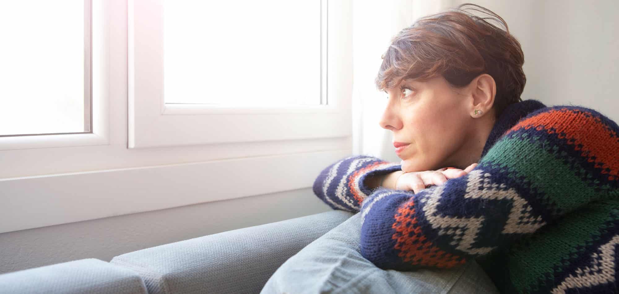 woman looking out window