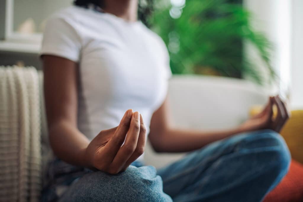 Close-up of a woman's hands in a meditative pose, highlighting the essence of mind and body connection somatic therapy promotes