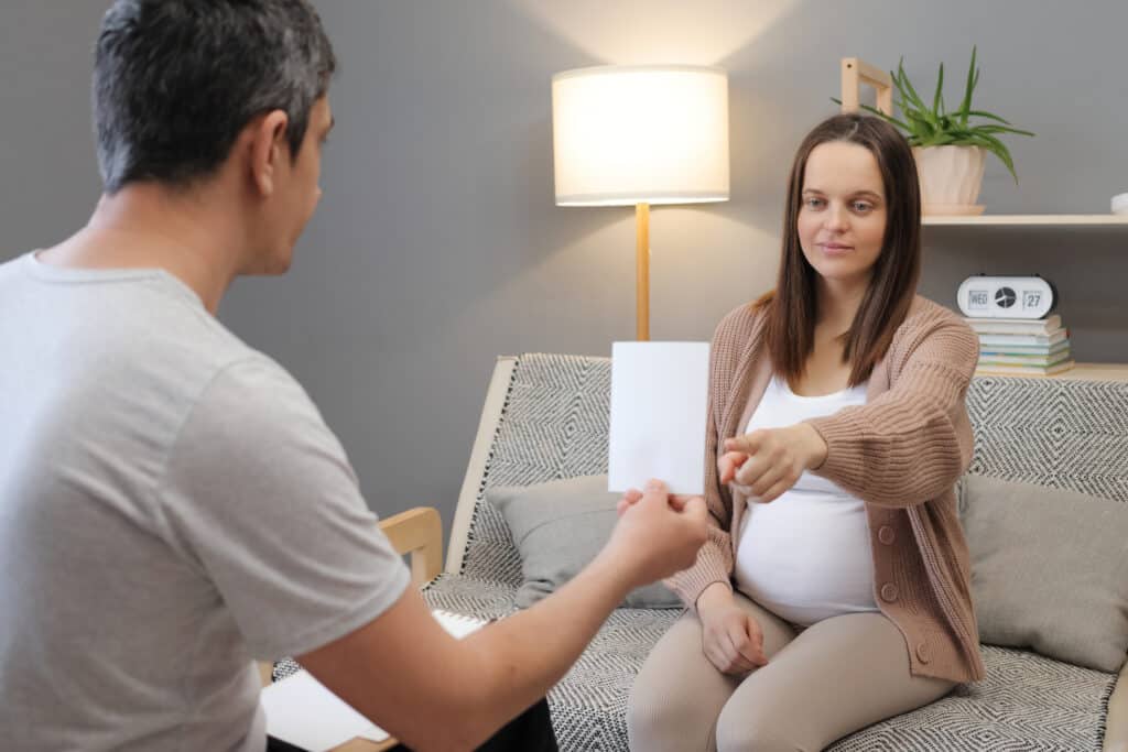 Male psychotherapist showing picture to woman client during a session working with somatic therapy for improved mental health